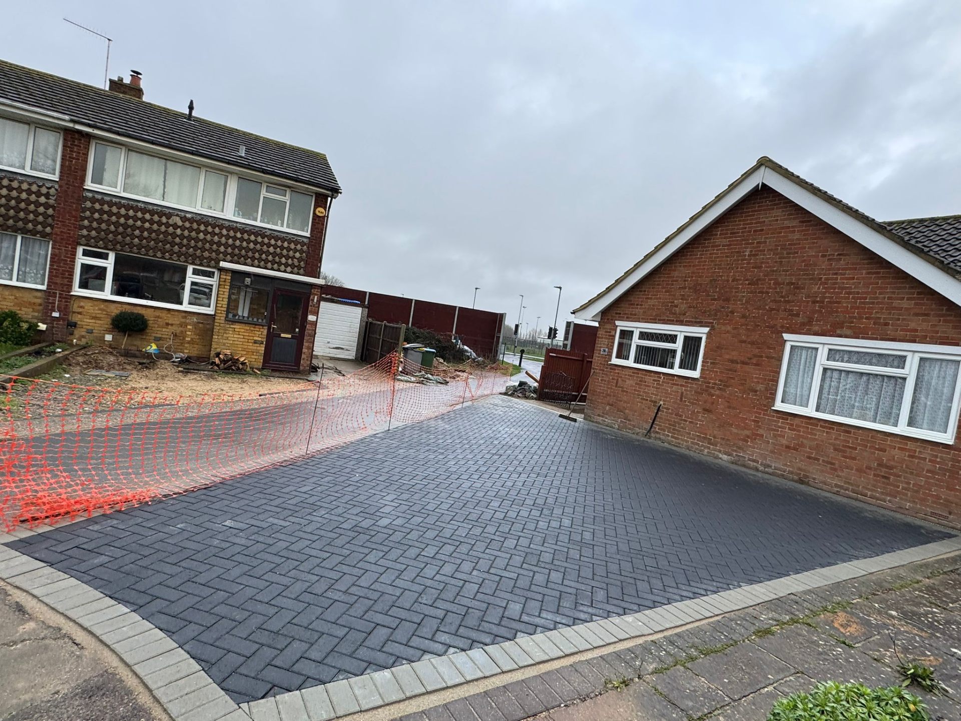 Charcoal block paved driveway laid in herringbone pattern with contrasting border by A Baker Construction West Sussex