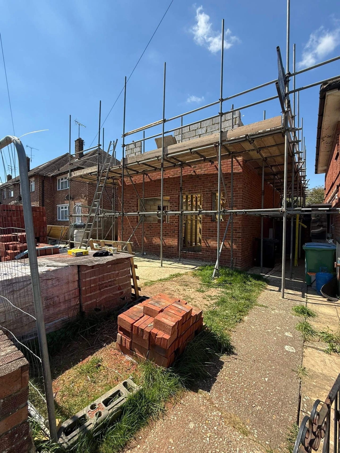 Exterior of new build brick shell under construction with scaffolding by A Baker Construction West Sussex