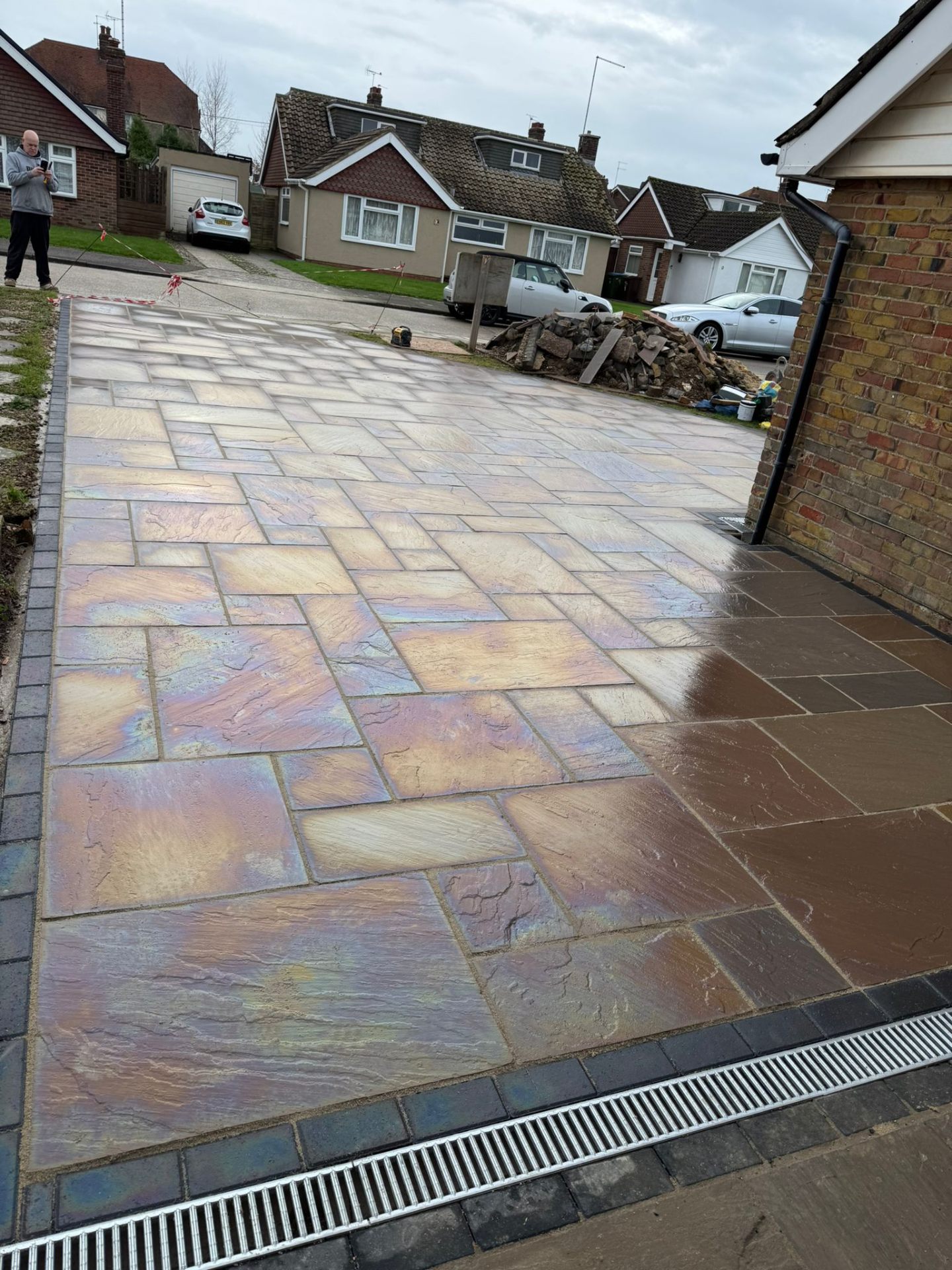 Rainbow sandstone paved driveway with ACO drainage channel by A Baker Construction West Sussex