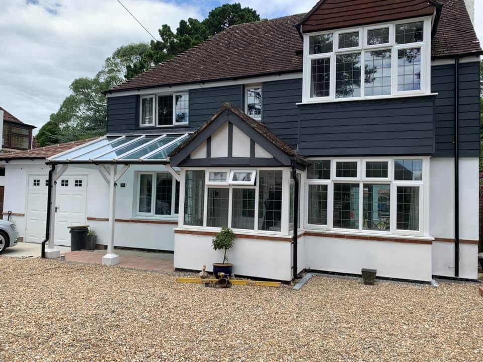 Completed two storey house extension with glass roofed orangery and gravel driveway by A Baker Construction West Sussex