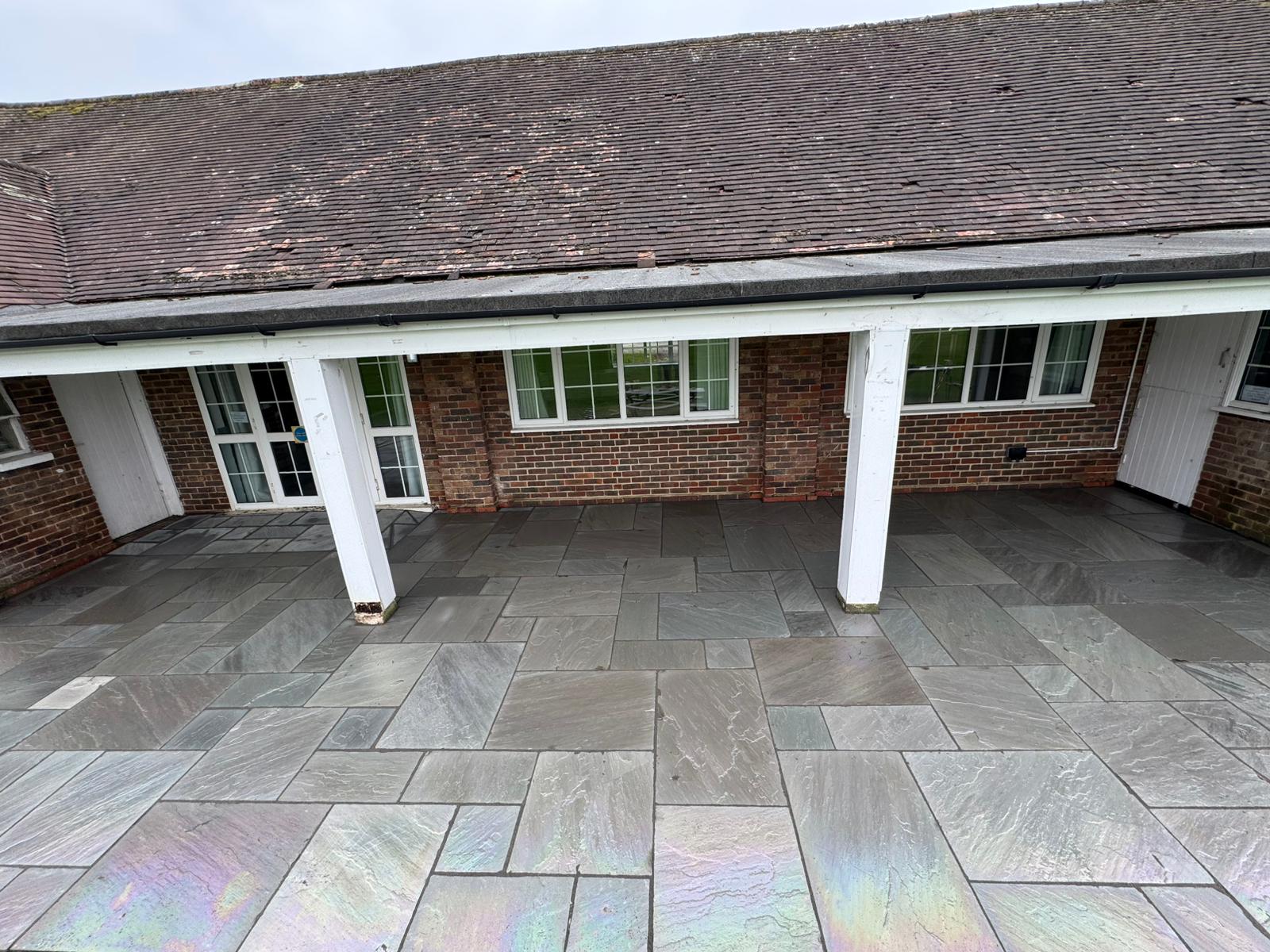 Large grey sandstone patio laid at commercial premises by A Baker Construction West Sussex