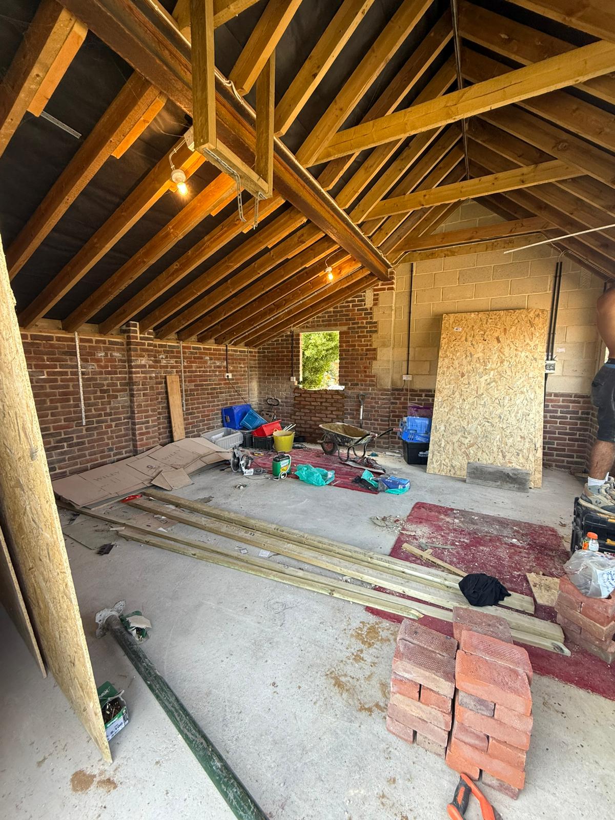 Bare brick interior during garage to living space conversion West Sussex