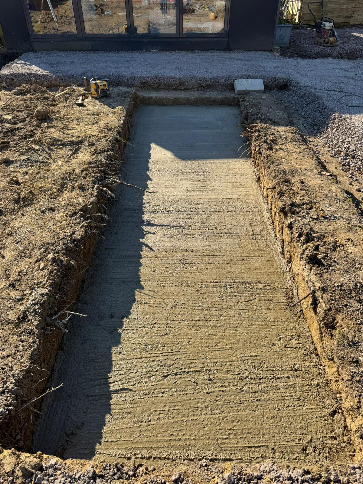 Concrete base poured for water feature during garden redesign West Sussex