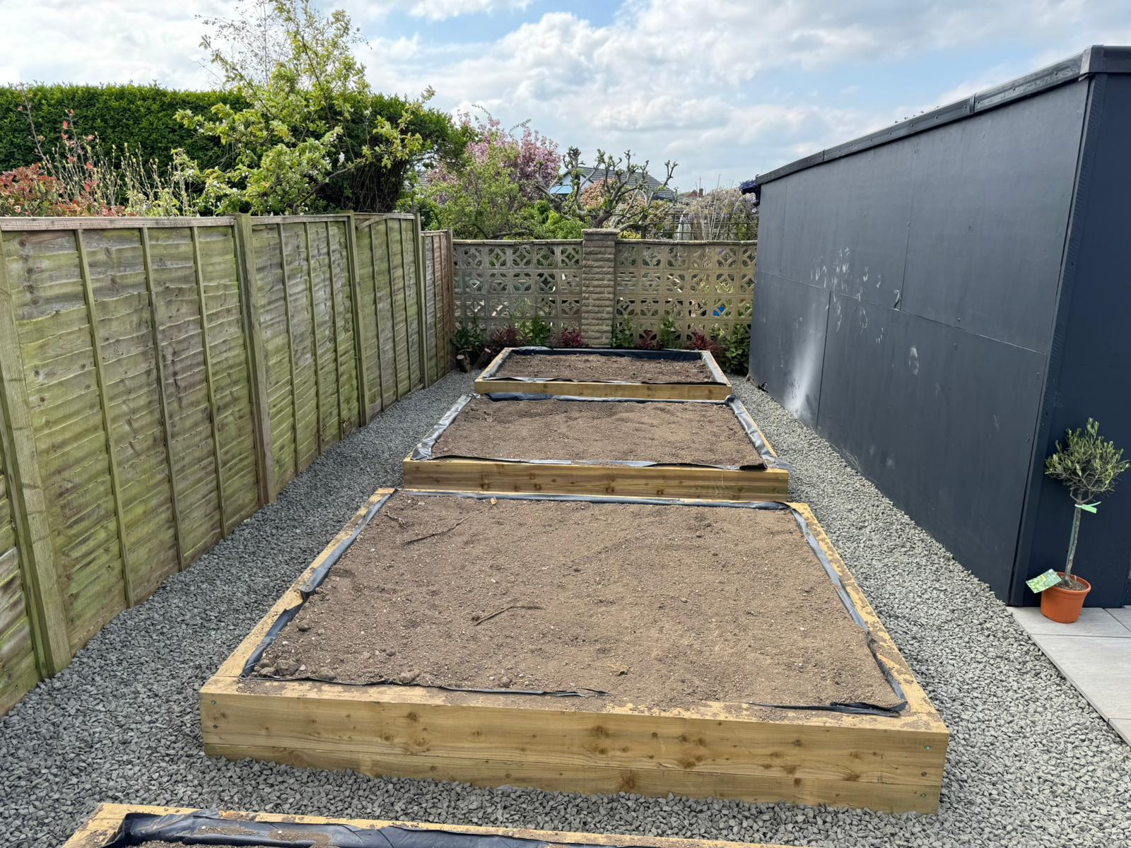 Large garden patio near completion with planting beds West Sussex