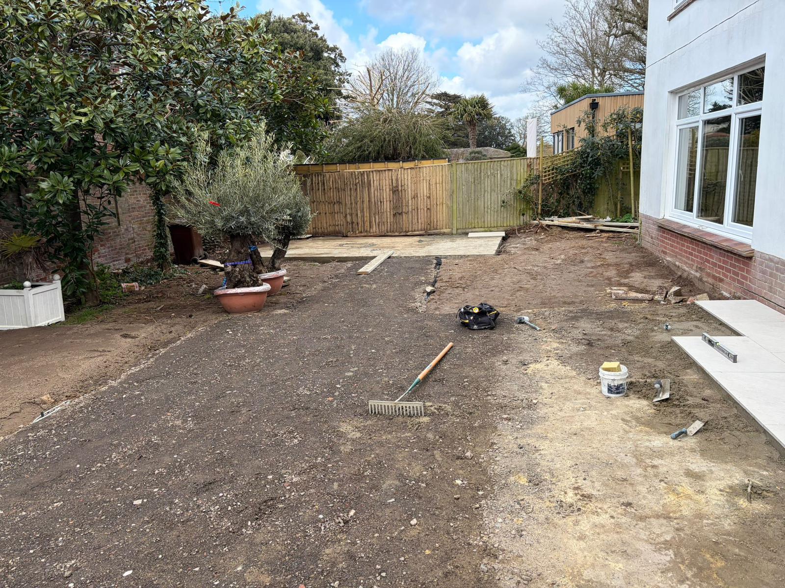 Porcelain patio slabs being laid during garden renovation West Sussex